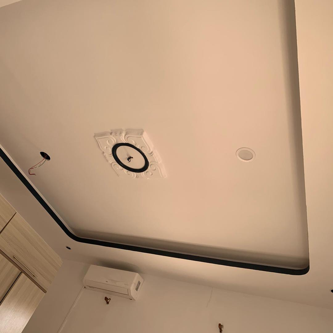 Finished ceiling with decorative cornice and recessed lighting